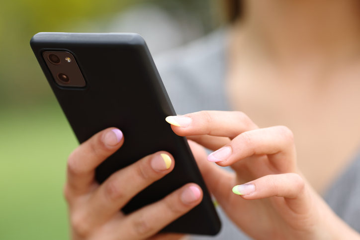 Close up of a woman hand using phone