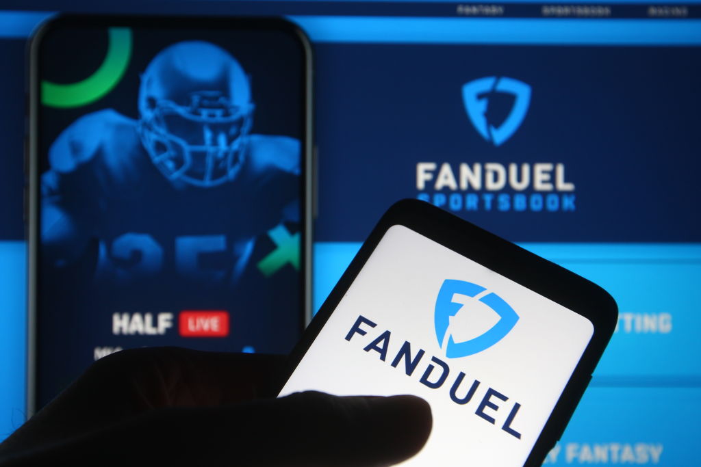 In this photo illustration the FanDuel logo of a sports...