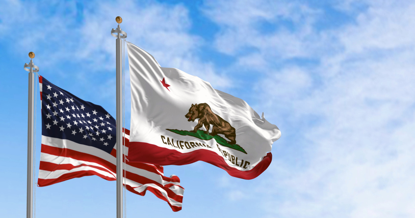 California and USA flags waving on a clear day
