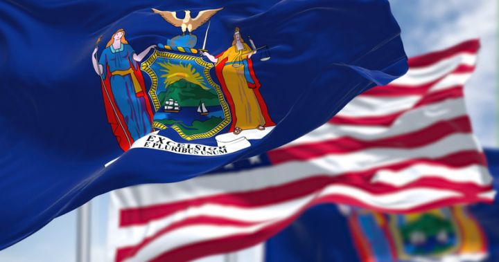The New York state flag waving along with the national flag of the United States of America