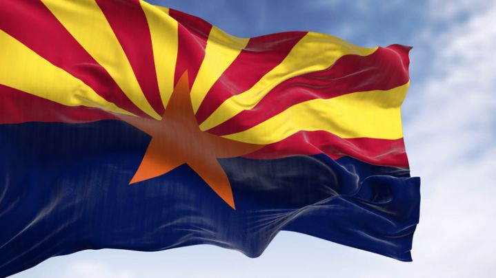 The flag of Arizona waving in the wind on a clear day