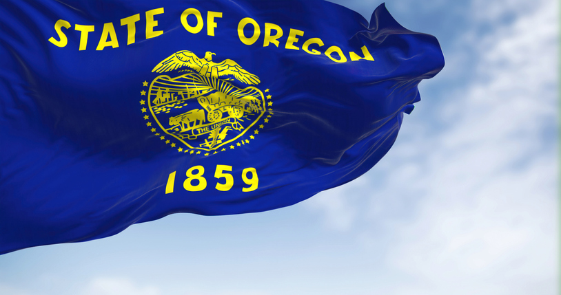 Close up view of the Oregon state flag waving on a clear day
