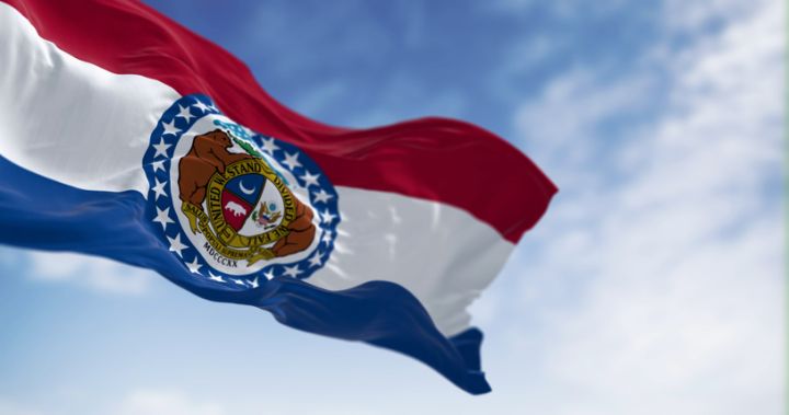 Missouri state flag waving on a clear day