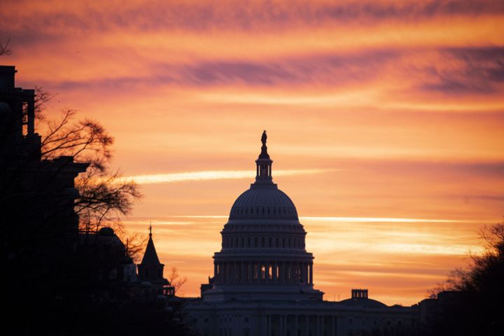 The US Capitol Building Against An Orange Sky
