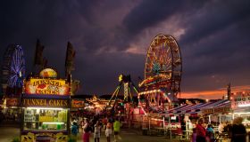 Games and rides illuminated against the night sky at the Maryland State Fair