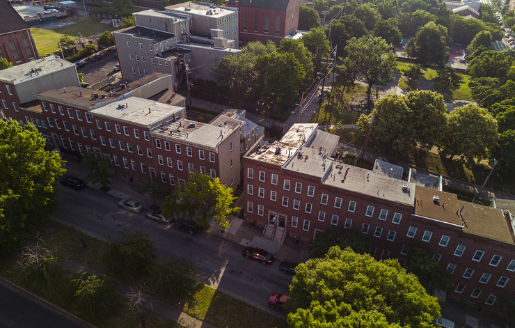 Broadway residential district of Baltimore, MD. Aerial view of brick Townhouses near green par kin sunny summer day