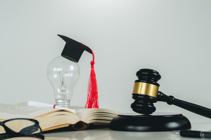 Education law concept.Scales of justice,law books,Graduation cap,light blub and book with white background.Justice legal and jurisprudence concept.
