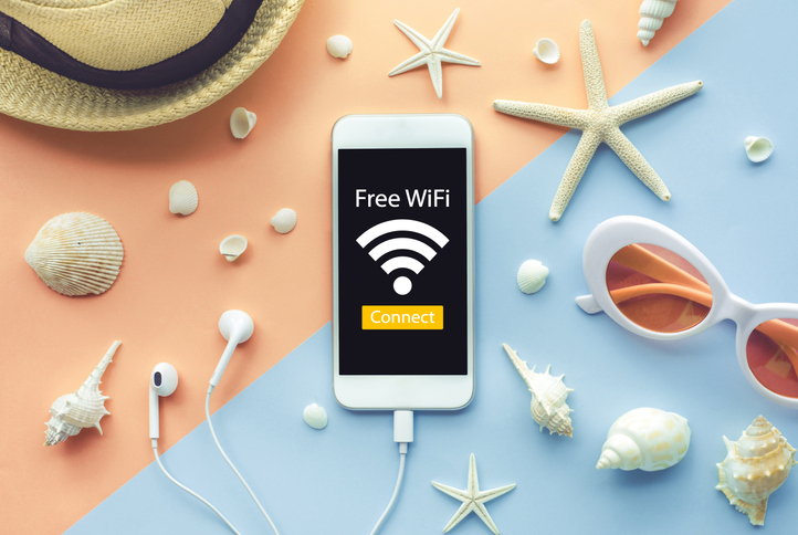 Free wi-fi and connect concept with smartphone and element of seashell on color background.Summer,holiday ideas