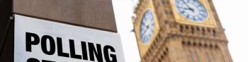 Closeup of polling station sign in front of Westminster