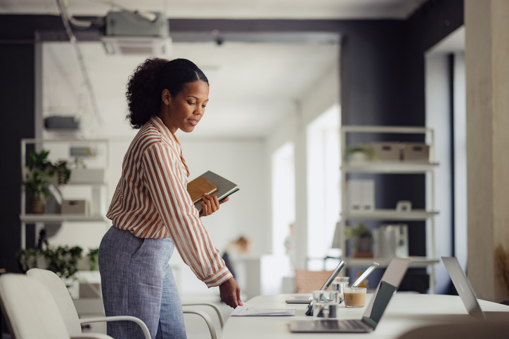 Professional Woman Preparing for a Business Meeting in Modern Office