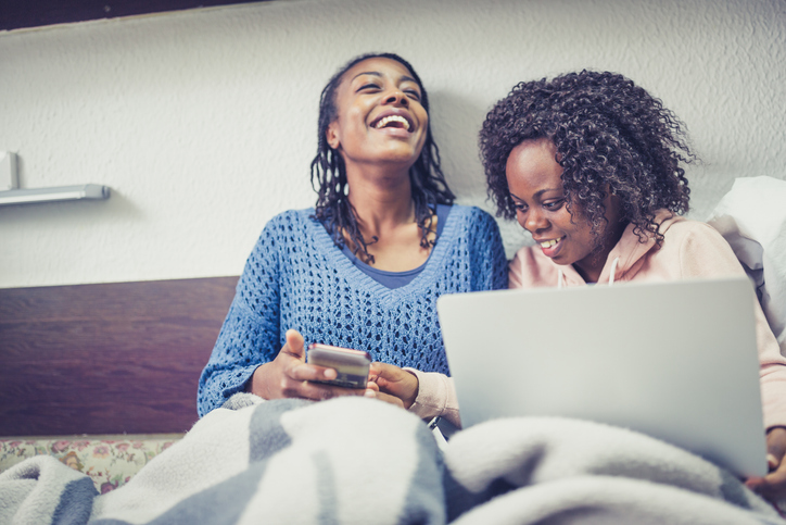 Joyful Evenings: Two Women Laughing and Enjoying Time Together