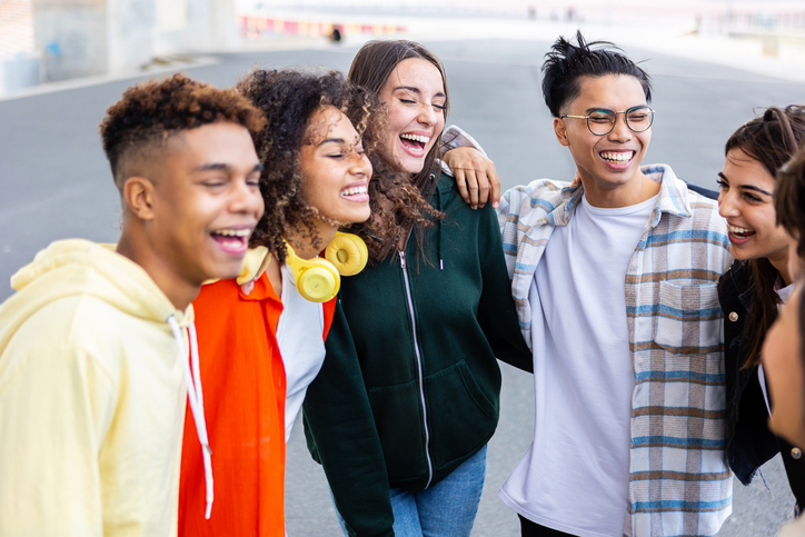 Happy group of young student friends having fun together outdoors