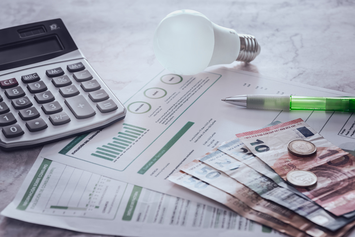 Electric light bulb and expense bill.