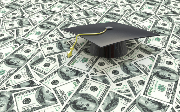 Mini graduation cap on US money -- education costs