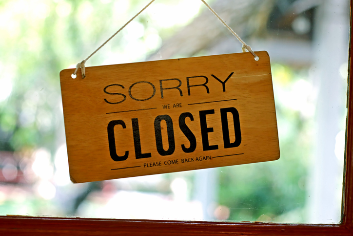 Closed shop sign. Sorry we're closed sign hanging on cafe glass door