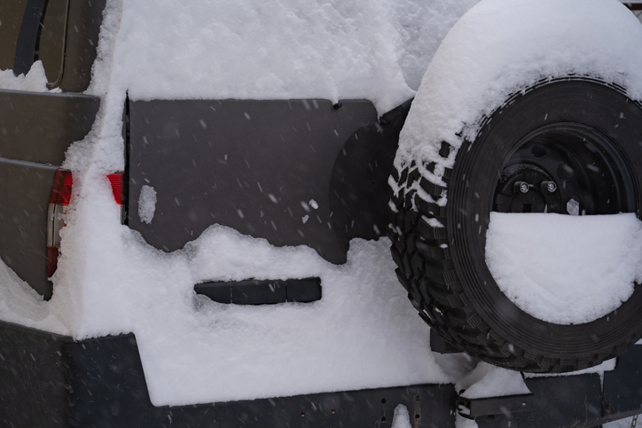 snow-covered passenger car, winter day, cyclone