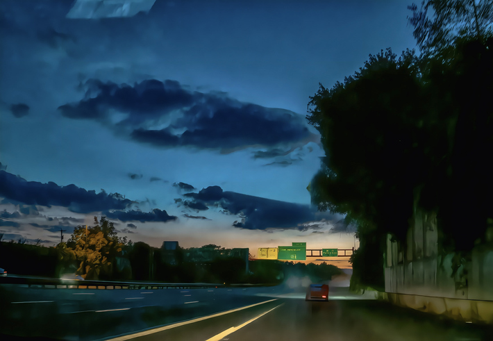 Driving on the highway on the setting sun