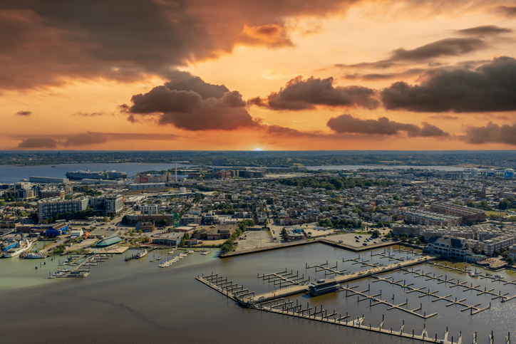 Aerial shot of the Patapsco River with boats and ships docked, apartments and office buildings in Baltimore Maryland USA