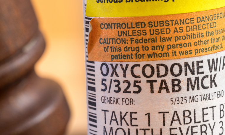Oxycodone opioid tablets with judge gavel for court decision about liability