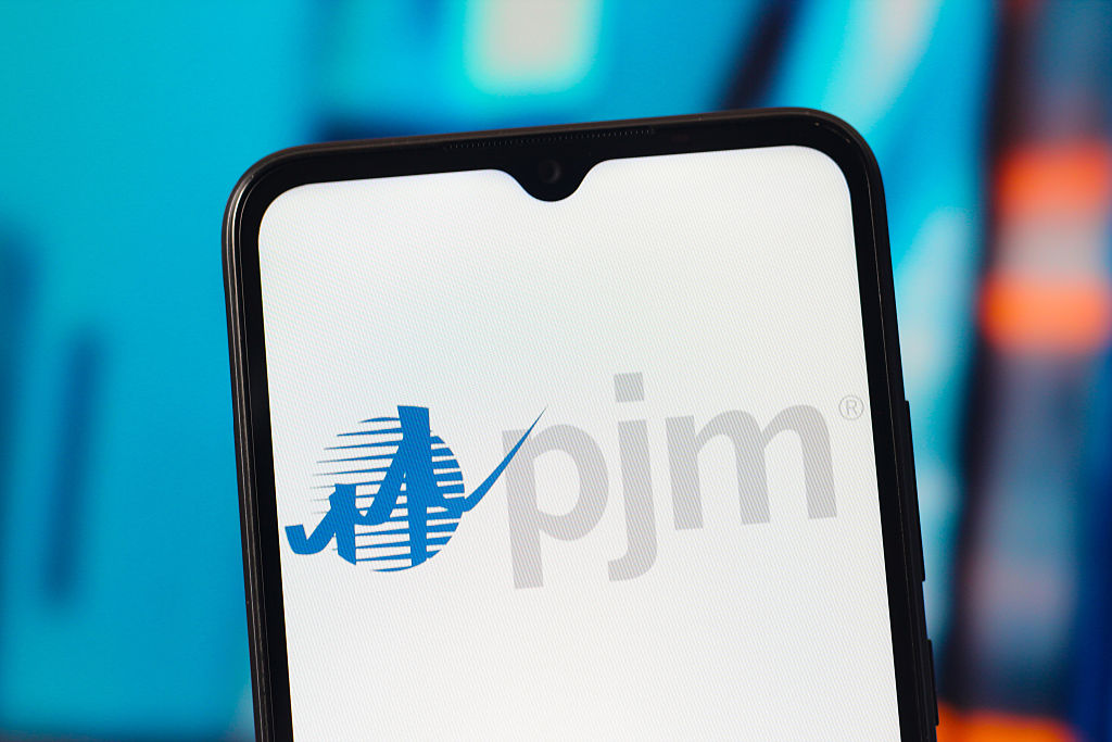 In this photo illustration, the PJM Interconnection logo is