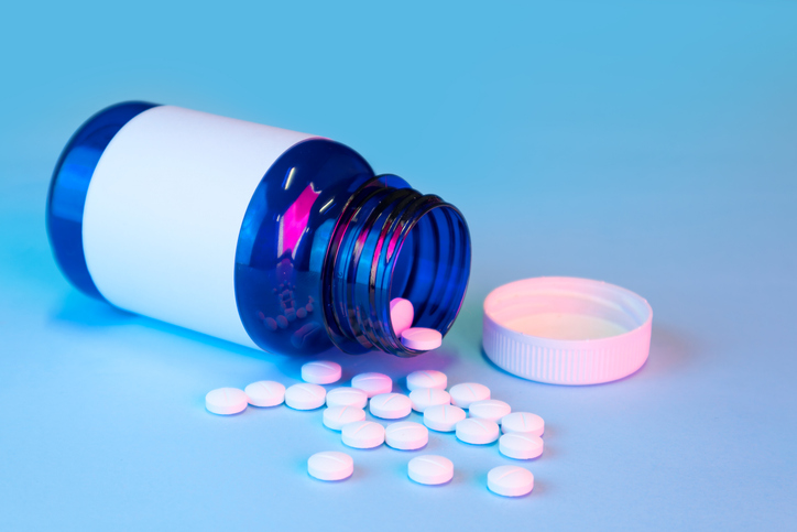 blue white label medication bottle with loose pills, mockup