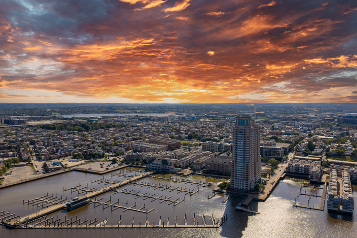 Aerial shot of the Patapsco River with hotels, apartments and office buildings in the skyline in Baltimore Maryland USA