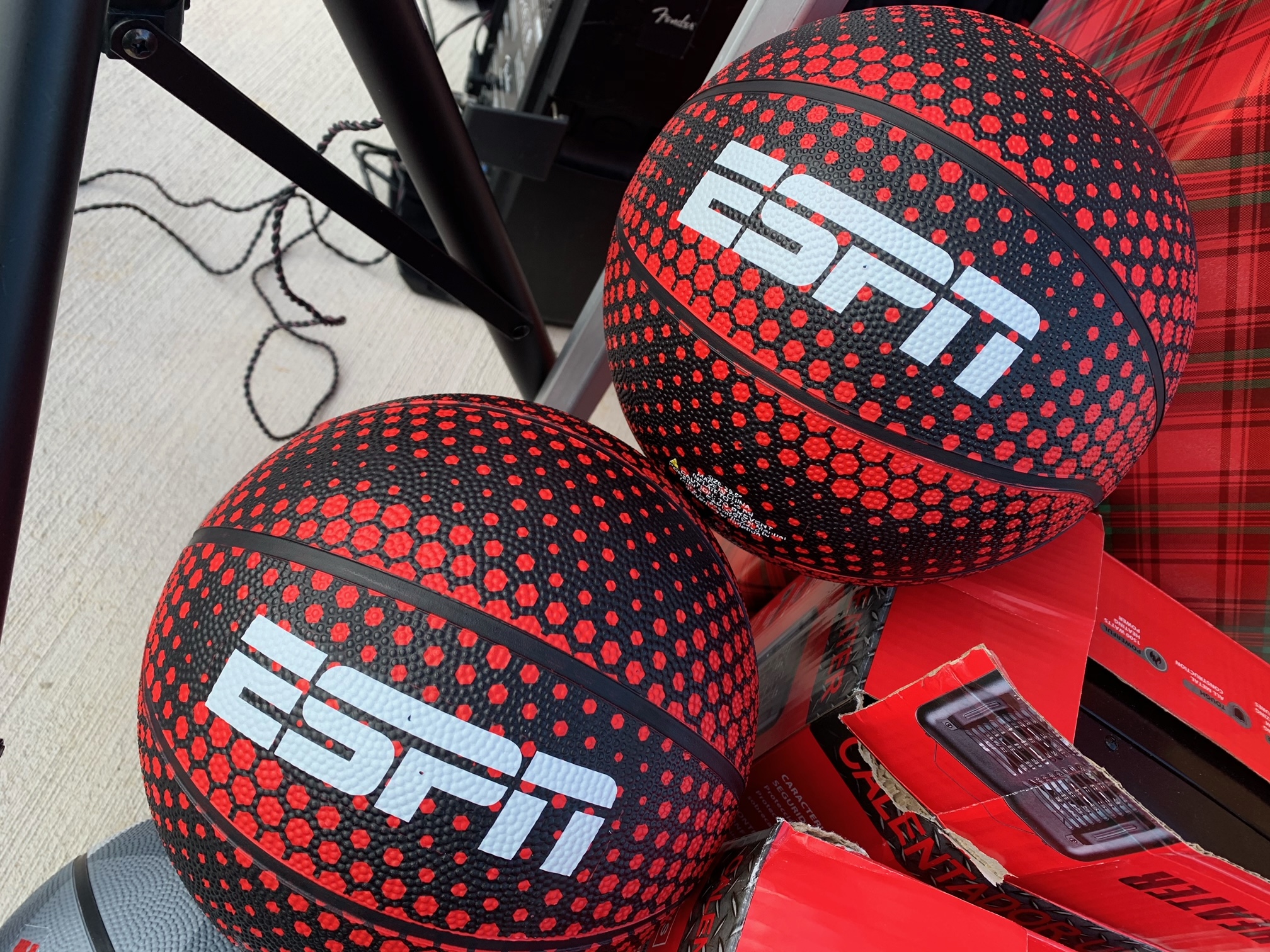 Two red and black basketballs with the text "ESPN" printed on them.