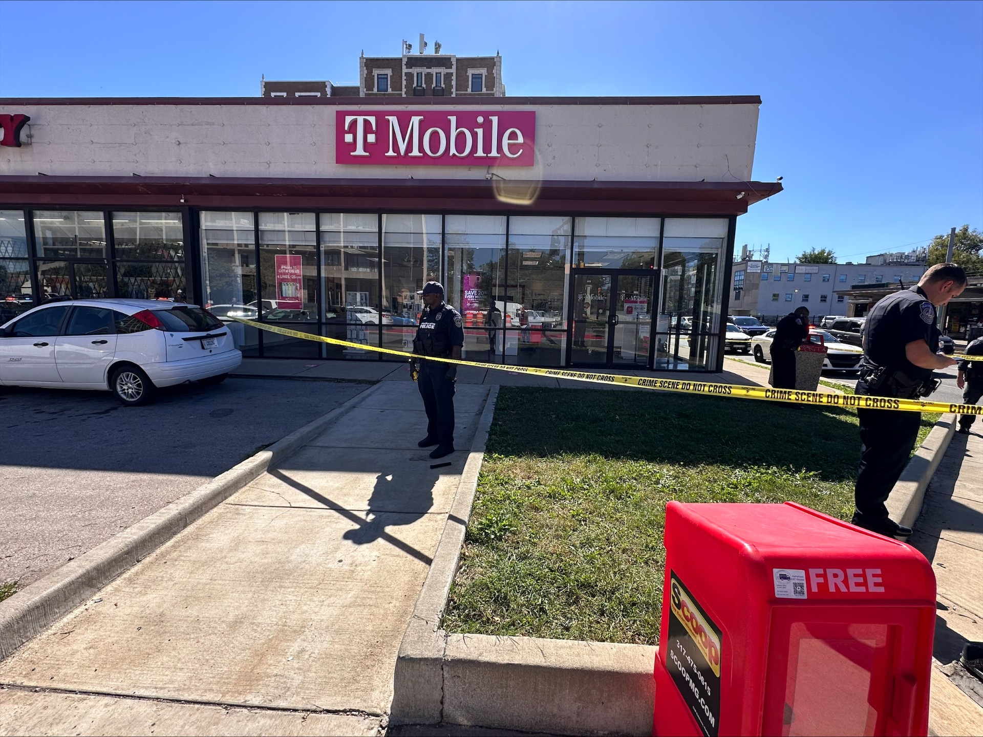 T-Mobile store with police tape and officers at the scene