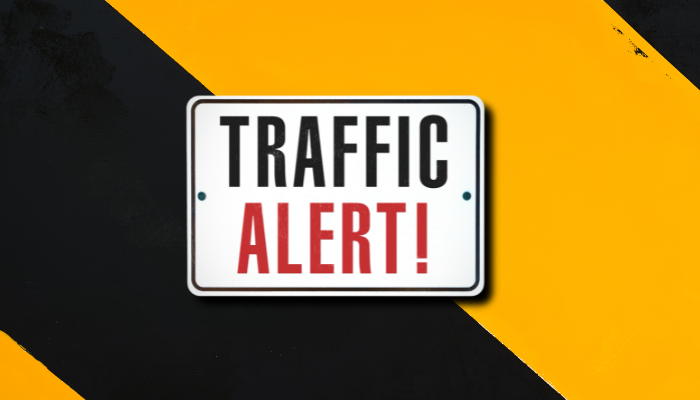 Traffic alert sign on orange and black background