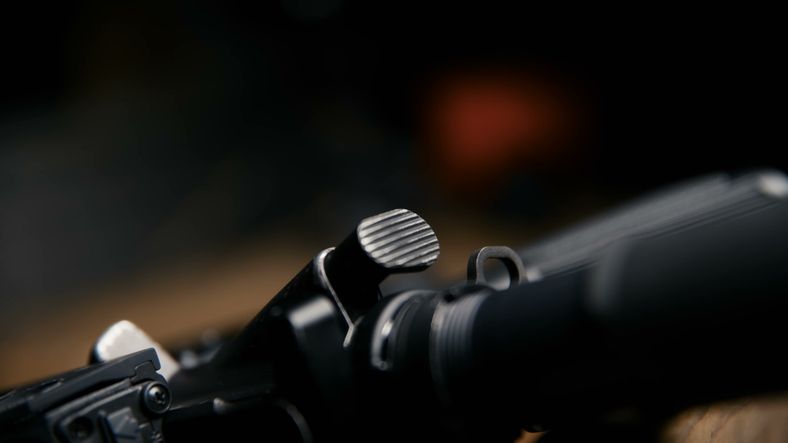 Close up view of the charging handle latch on a modern tactical rifle