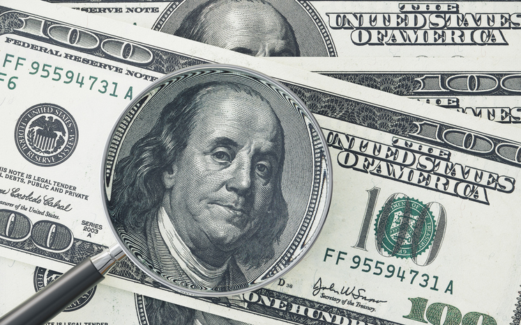Magnifying Glass Examining 100 American Dollar Banknote Representing Financial Analysis And Currency Investigation