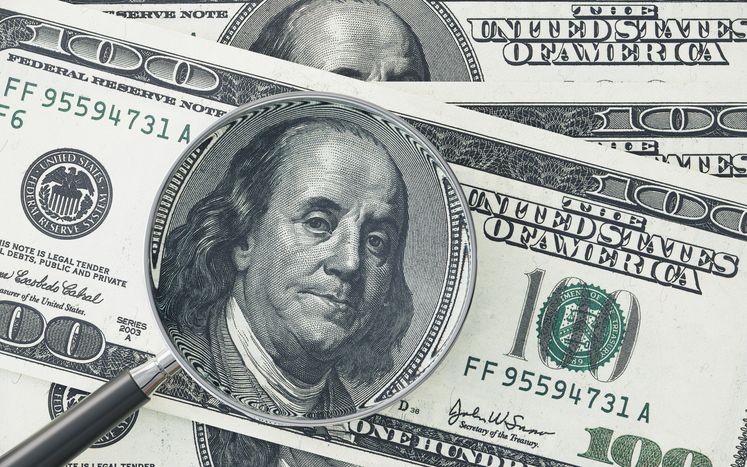 Magnifying Glass Examining 100 American Dollar Banknote Representing Financial Analysis And Currency Investigation