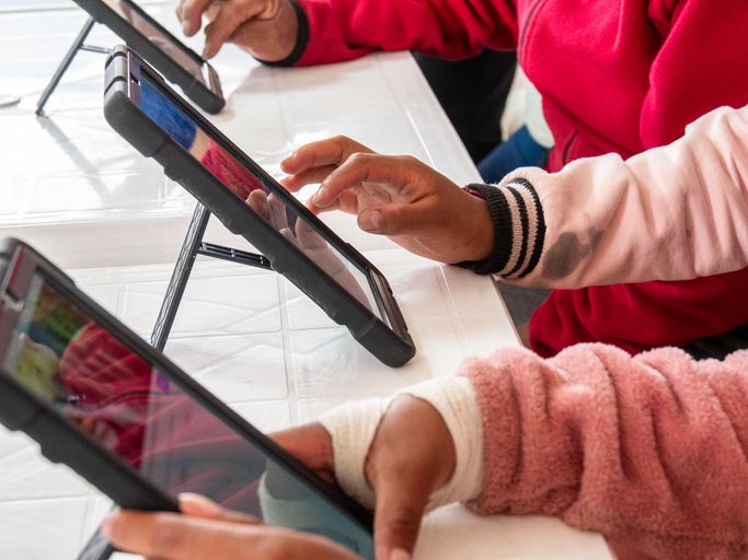 Children Using Tablets During Collaborative Digital Learning Activity