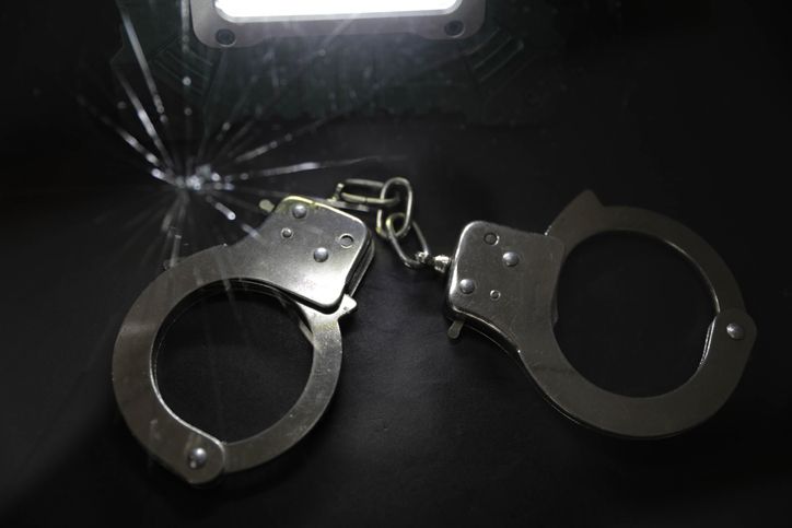 Police Handcuffs on Black Background