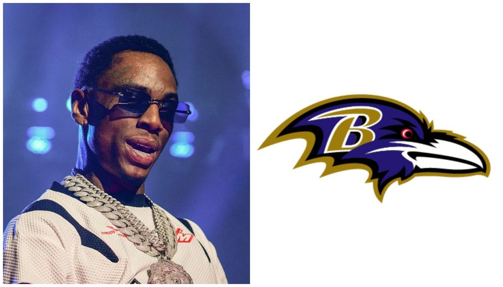 A man wearing sunglasses and a white outfit with a large chain necklace, performing on stage with a purple and yellow Baltimore Ravens logo in the background.